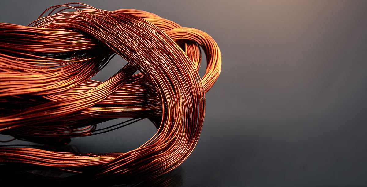 Coiled copper wire on a dark background